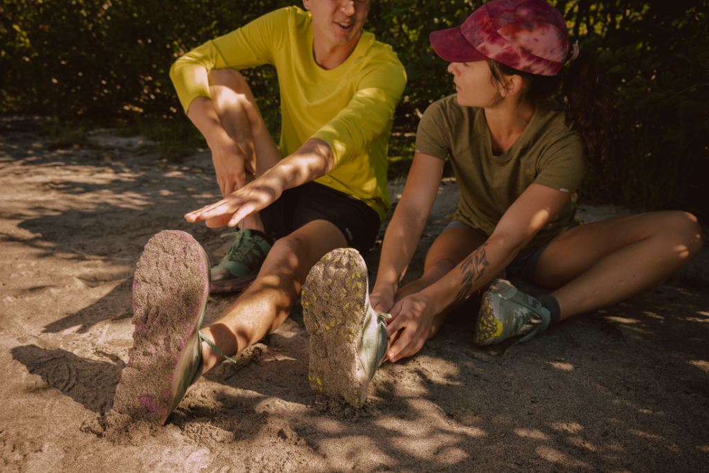 Two runners stretch before a workout.