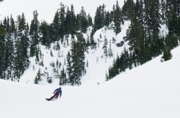 A solo snowboarder in a snowy mountain landscape.