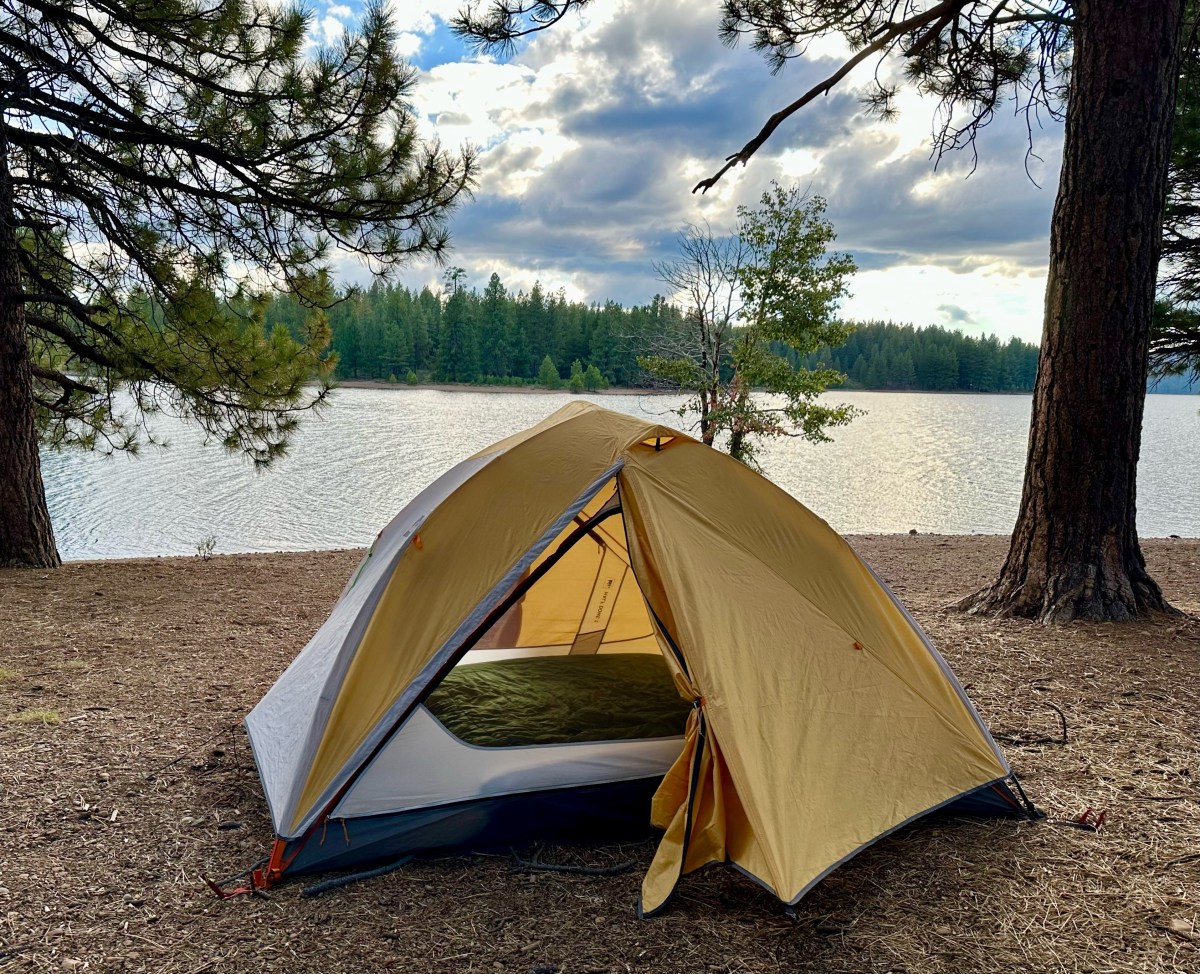 Photo of a Half Dome Tent in front of a lake.