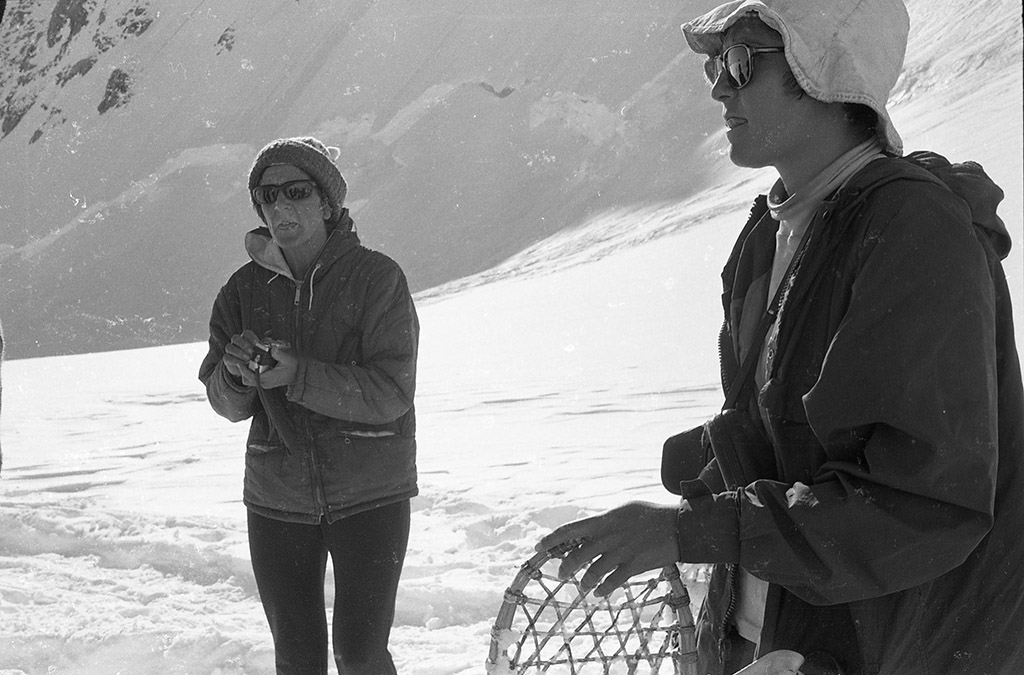 A black and white photo of two women on a snowy mountain